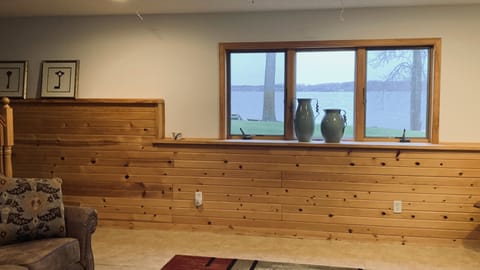 Basement has a living room . Ping pong table , air hockey table and TV. 