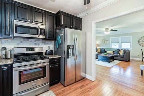 This full-size apartment kitchen features a gas stove and oven, fridge, dishwasher, microwave, toaster, and is fully stocked with spices and all essentials. It has everything you need for cooking, making it perfect for any culinary adventure.