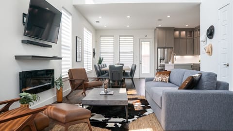 Living room is full of entertainment features, large HDTV and electric fireplace