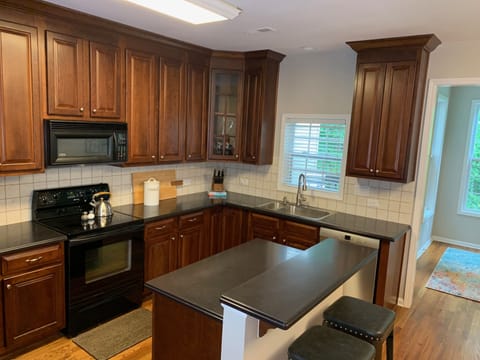 Full kitchen with cooking necessities.