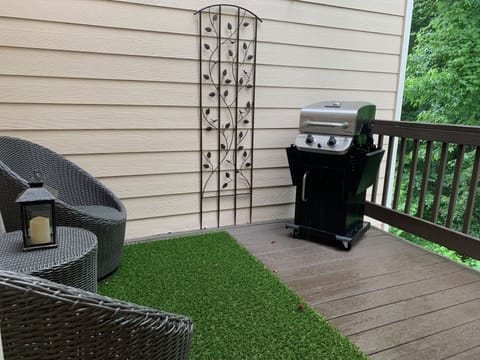 2nd floor private outdoor deck with seating and gas grill.