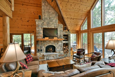 Two story vaulted greatroom with wood burning stone fireplace.