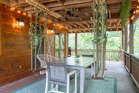 Hang out and snap some pics on the outdoor dining table with hanging swings