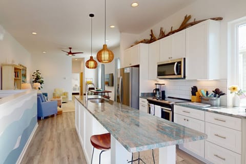 Enjoy the stunning counter tops and huge island in this modern kitchen