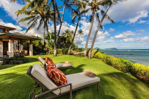 Wake to swaying palms, ocean breezes, and turquoise waters just beyond the lawn.