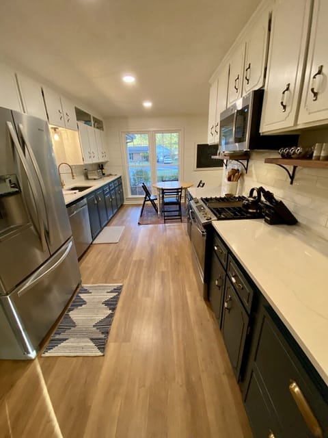 Newly renovated kitchen with stainless appliances and quartz countertops.