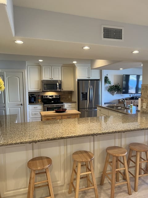 1st floor fully stocked kitchen with extra seating around the counters.