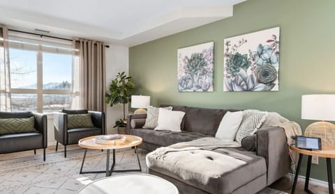Living room with a Smart TV, Wii-U game console, cozy seating options and walkout access to the private ground-floor patio.