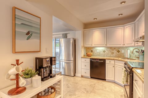 Galley kitchen with coffee bar/station.