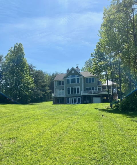 Back of house with large yard for lawn games