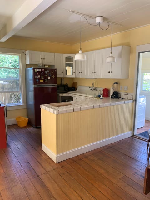 Kitchen into laundry room leads to sunny back deck.
