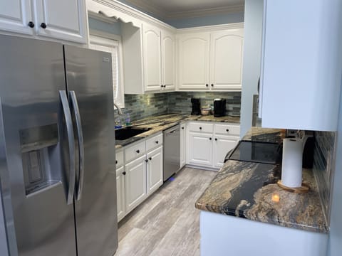 Newly refreshed full kitchen with granite and updated stainless appliances