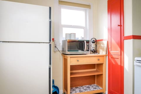 Full refrigerator/freezer, microwave, and closet ironing board.