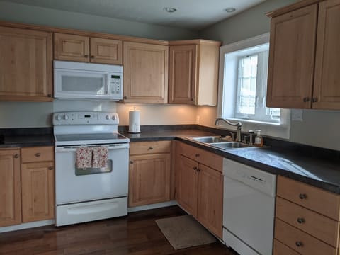 Spacious kitchen complete with all the essentials. Also includes dining table.