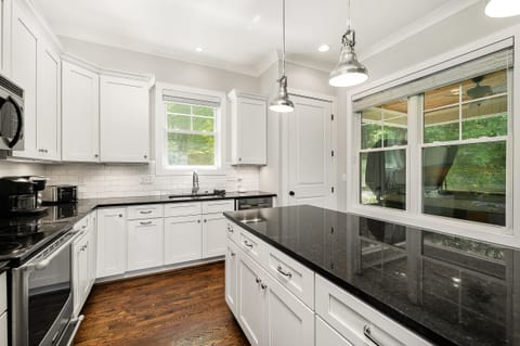 From the kitchen, you'll overlook the hot tub located in the screened porch