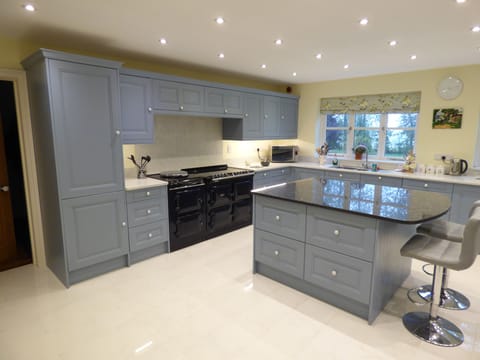 modern kitchen with granite worktops and Aga cooker