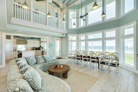 Walls of windows showcase the beautiful beachfront views