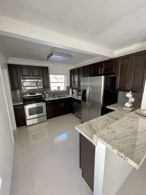 Full kitchen with range, stovetop, dishwasher, refrigerator,blender, toaster et