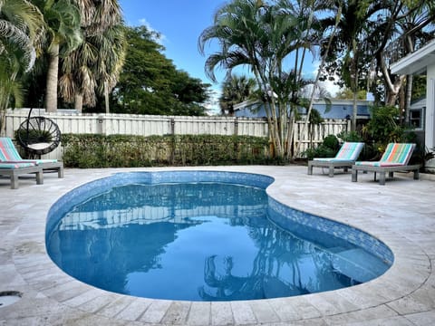 Heated private pool with 4 lounge chairs and a swing chair