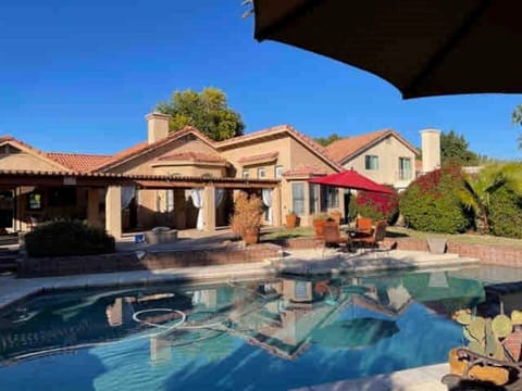 Lakeside looking toward the home over the very large heated pool, a quiet resort