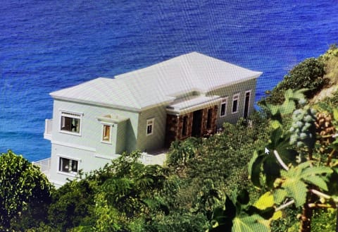 Perched on a hill above the sea.