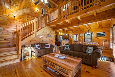 Living room with open loft above 