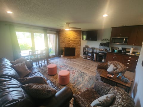 Open concept living room with views to patio