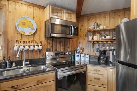 Provided hanging glassware, multiple forms of coffee makers, toaster oven, rice cooker and a blender