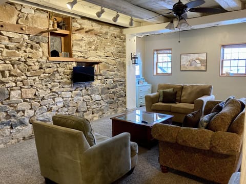 Main living area features a large comfy seating group and TV.