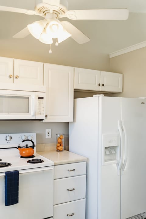 It is a full kitchen with side-by-side refrigerator.