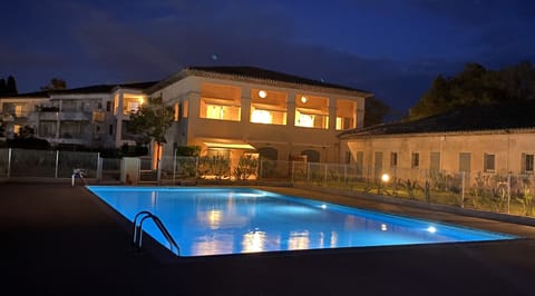 The Residence & Pool by night