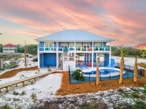 Beachside view of house w/sunset sky