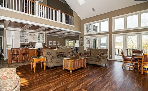 Family room, view of kitchen, dining, sunroom, and loft