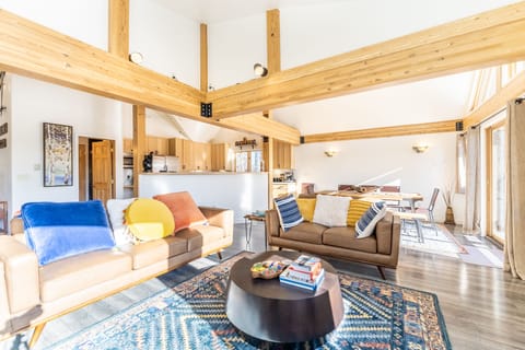 Spacious living area with panoramic windows, incredible light, flat screen TV, hardwood floors and ample seating.