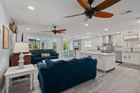 An open kitchen, living, and dining area filled with natural light, creating a bright and airy space for easy living and entertaining!