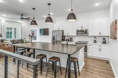 Open-concept floor with large kitchen island for cooking and dining.