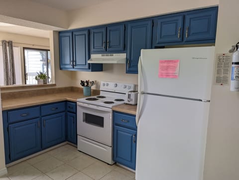 Pass through into the dining room, electric stove and ice maker in freezer