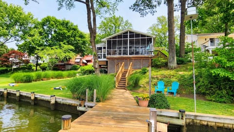 Enjoy screened in porch with dining table and sitting area