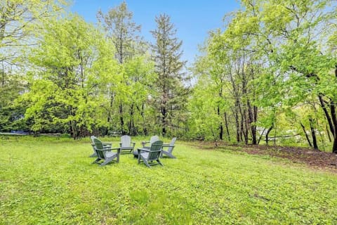 Back yard fire pit with 6 Adirondack chairs.