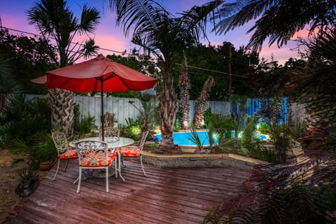 Deck area w/ patio table for 4, 2 chaise lounge chairs & tropical plants