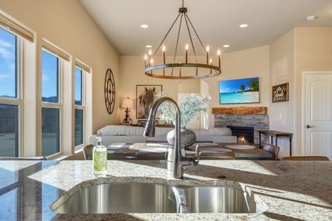 Kitchen sink has a mountain view and TV view