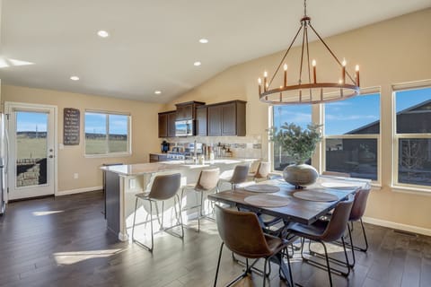 Dining area with custom wood table & 6 chairs and breakfast bar with 4 stools.