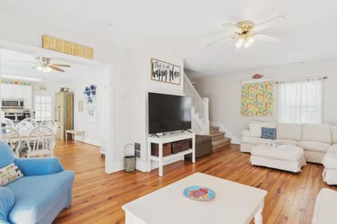 Living room with large TV and lots of seating for the family.  