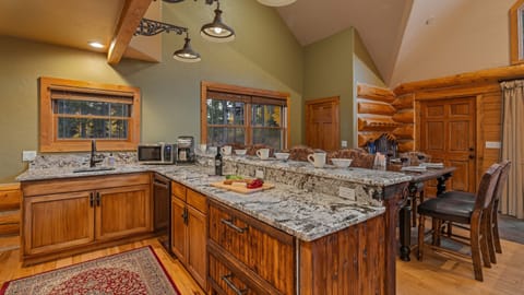 Family room with bar and hightop dining table on upper level wing