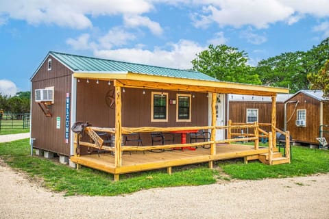 Your rustic and sturdy front porch is nicely shaded, and equipped with relaxing outdoor furniture.