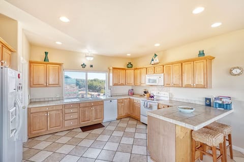 Open and well-lit allows for multiple hands in the kitchen. Features instant hot water tap.