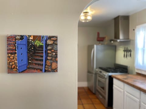 Beautiful adobe style arches and saltillo mixed w/ hardwood flooring throughout