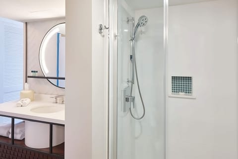 Rinse off in a sleek glass shower after beach time.