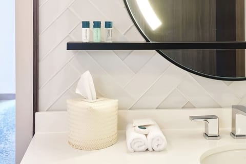 Refresh at a glowing vanity with plush towels ready.