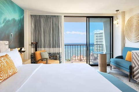 Breathe in sea air from bed with balcony beyond.